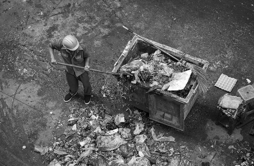 Construction workers removing debris from a building site in Eltham